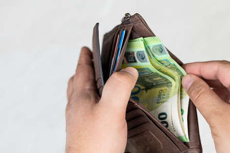 Wallet with 100 euro money in the hand with copy space.