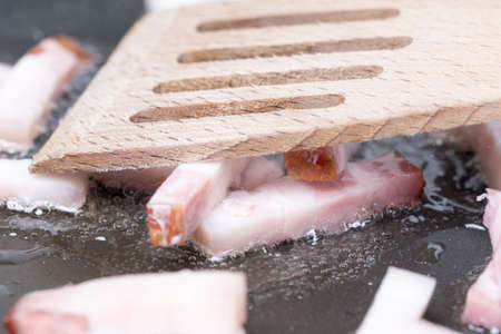 Frying sliced bacon in the frying pan.の写真素材