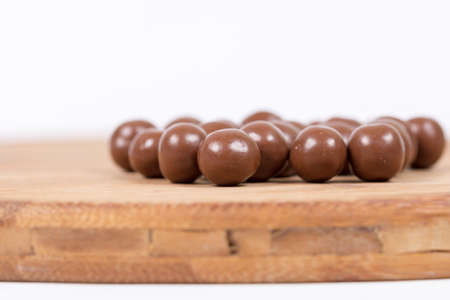Chocolate round beads marbles sweet cookies macro closeup.の写真素材