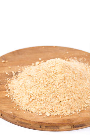 Pile of grounded biscuits on the wooden board.の写真素材