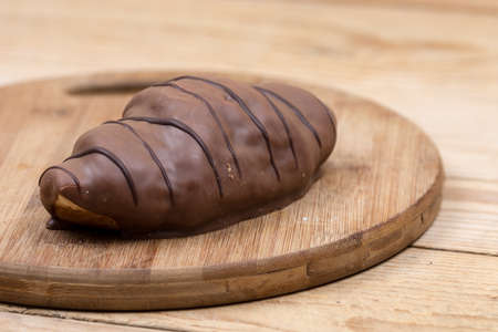 Fresh chocolate croissant on the wooden board.の写真素材