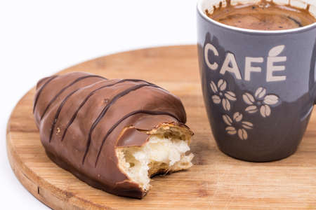 Cup of coffee with chocolate croissant and copy space.