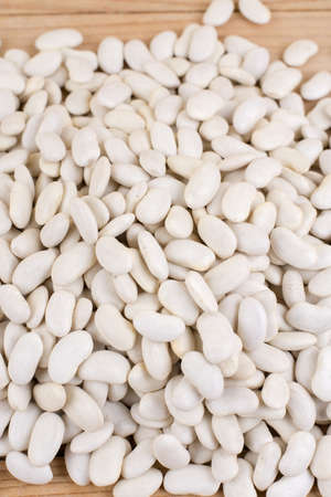 Pile of white beans on the wooden table.の写真素材
