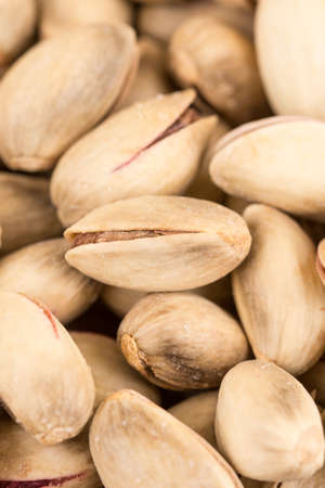 Pile of roasted pistachio on the wooden table.の写真素材