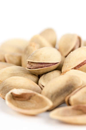 Closeup macro roasted pistachio over white background.の写真素材