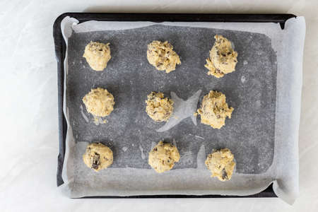 Raw crisp cookies prepared for baking on baking tray.