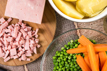 Chopped ham with cooked green peas carrot and potatoes.の写真素材
