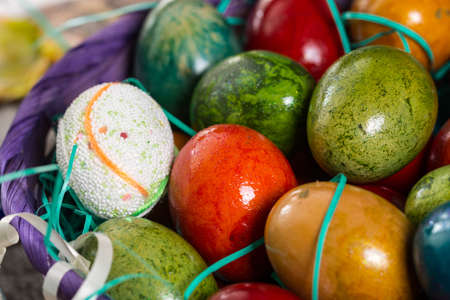 Closeup macro of colored Easter eggs in the basket.