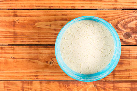 American pancakes mixture compound over flat lay wooden rustic background.の写真素材