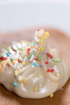 Chocolate cream with colorful sprinkles on the american pancakes.