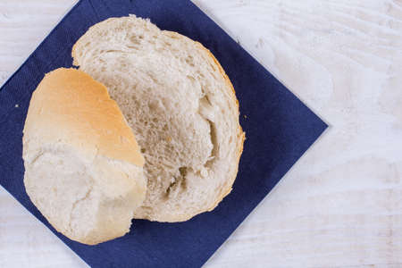 Sliced bread on the blue napkin over wooden background.の写真素材