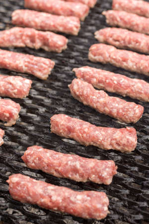 Grilling minced meat kebabs on the barbecue flat lay.の写真素材