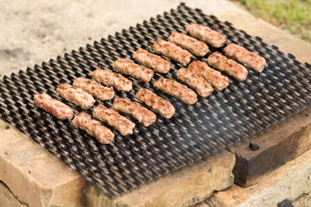 Grilling kebabs on the barbecue grill. Selective focus on the minced meat kebabs.