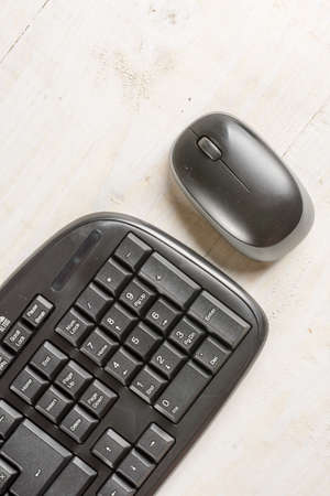 Closeup macro black pc keyboard with black wireless mouse.