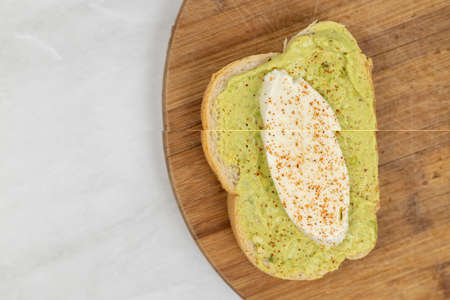 Sliced mozarella on the avocado spread toast.