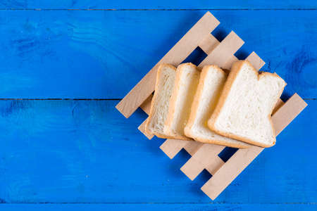 Toast bread slices on the blue wooden planks board.の写真素材