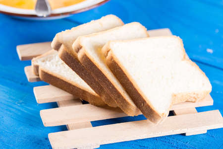 Slices of bread on the blue wooden background.
