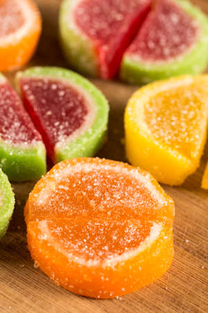 Colorful jelly candies on the wooden board backgroundの写真素材