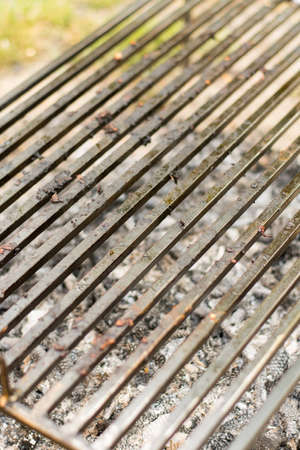 Empty barbecue grill with embers under barbecue grillの写真素材