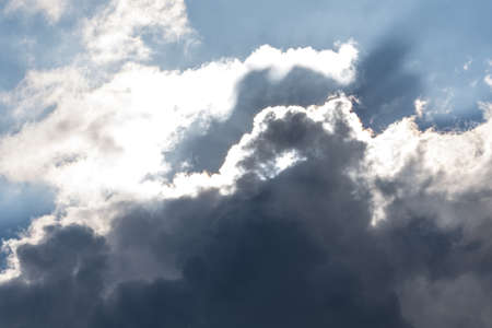 Abstract background with clouds formations and sun in background.