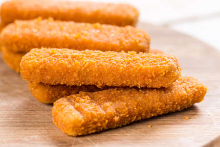 Fish meat sticks on the kitchen wooden board.の写真素材
