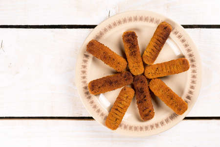 Flat lay above fried fish meat sticks on the plate.の写真素材