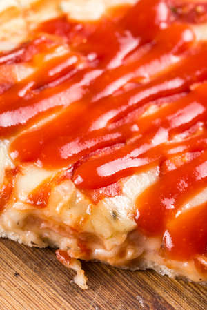 Closeup macro pizza slice with tomato sauce and mushrooms and cheese.の写真素材