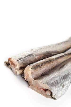 Sliced raw hake fish on the white background.