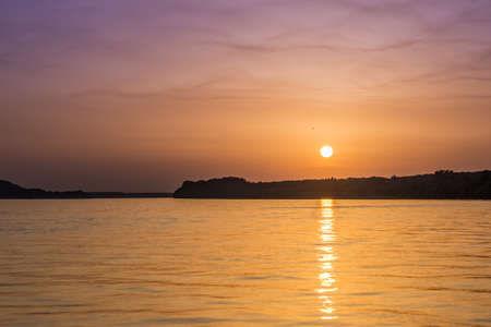 Beautiful unreal abstract colorful sunset on the Danube river.の写真素材