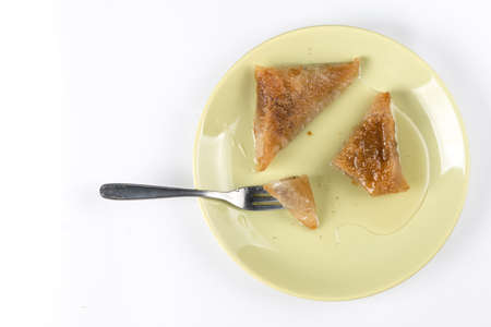 Flat lay traditional walnuts baklava on the plate with copy space above white background.の写真素材