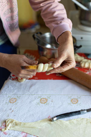 Woman hands creating dough cake in the dark moody light.の写真素材