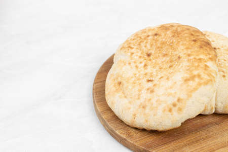 Homemade traditional lepinja bread on the wooden board.