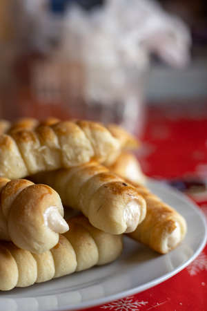 Homemade stuffed dough rolled cookies in low key light.の写真素材