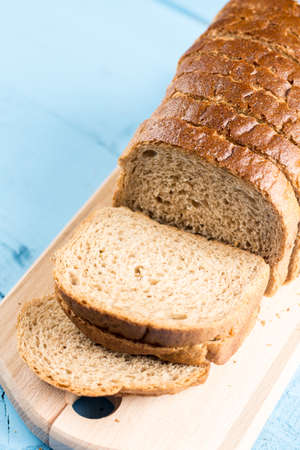 Toast bread slices on the wooden cutting board.