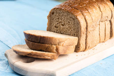 Toast bread slices on the wooden cutting board.