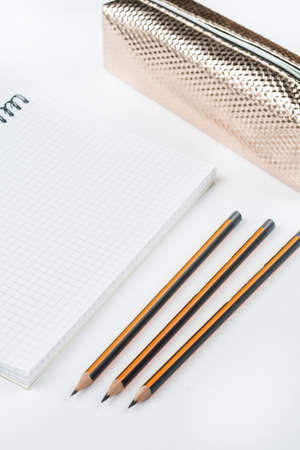 School notebook with wooden graphite pencils and pencil case with copy space.の写真素材