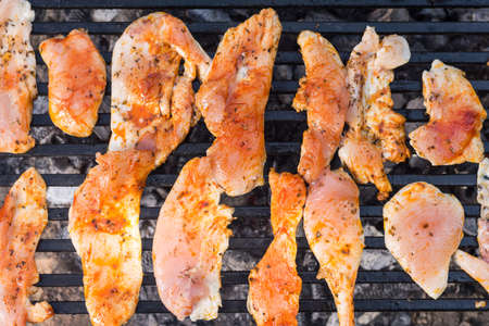 Flat lay above chicken breasts fried on the barbecue grill.