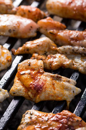Selective focus on chicken breasts frying on the barbecue grill.の写真素材