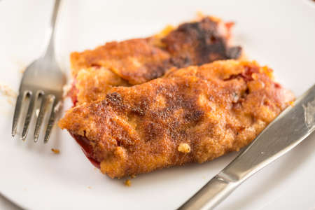 Grilled and fried in eggs paprika with knife and fork on the plate.