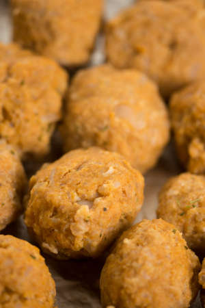 Homemade raw minced meat meatballs on the baking tray.の写真素材