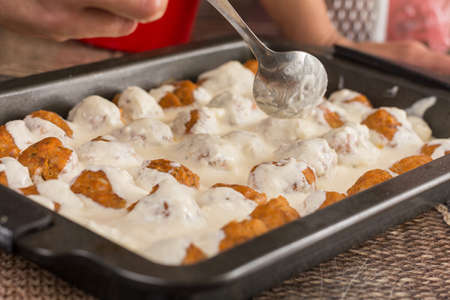 Homemade minced meat meatballs with yogurt ready for baking.の写真素材