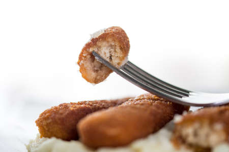 Closeup macro fish sticks served with mashed potatoes.