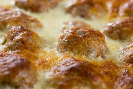 Meatballs baked in the oven with yogurt and melted cheese.の写真素材