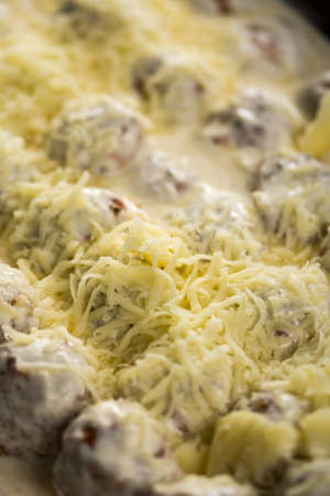 Meatballs with yogurt sauce and cheese ready for baking.の写真素材