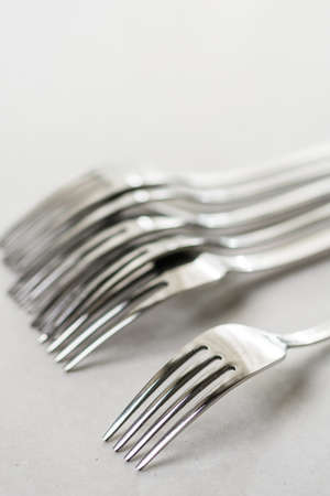 Metal forks on the white marble background table.の写真素材