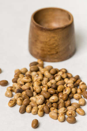 Soya beans with wooden pot on the white marble background.の写真素材