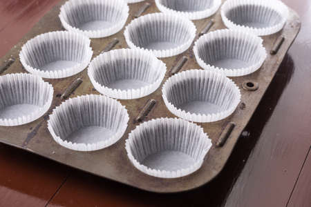 Empty white cup cakes papers ready for baking.の写真素材