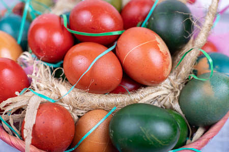 Closeup of colorful easter eggs in the basket.