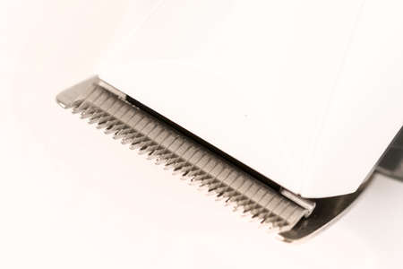 Closeup macro of haircut trimmer knifes isolated above white background.