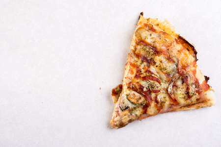 Pizza slice isolated above white marble background table.